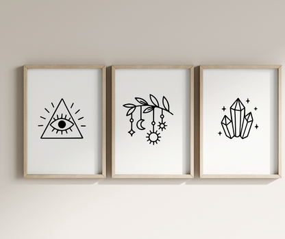 Three framed prints with geometric designs on a plain wall.